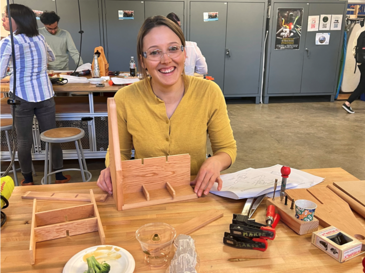CEAS staff smiles at the Wooden Beverage Holder Crafting Event 2022