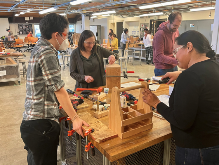 CEAS team building a Wooden Beverage Holder at the Crafting Event 2022