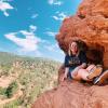 Brooke relaxes on a rock outcropping during a hike