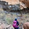 Tomoko looking up at a rock formation during a hike