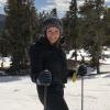 Female on skis in mountains