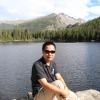 Wangda Zuo on the shore of a mountain lake