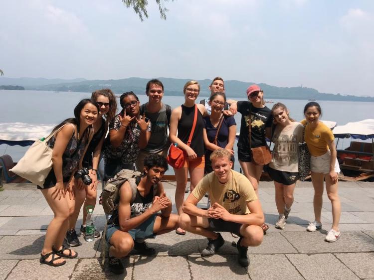 A group of students posing for a photo while visiting West Lake in Hangzhou, China.