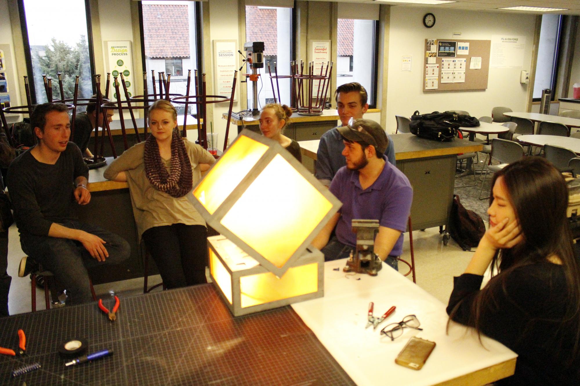 The class illuminates the prototype during a work session. 