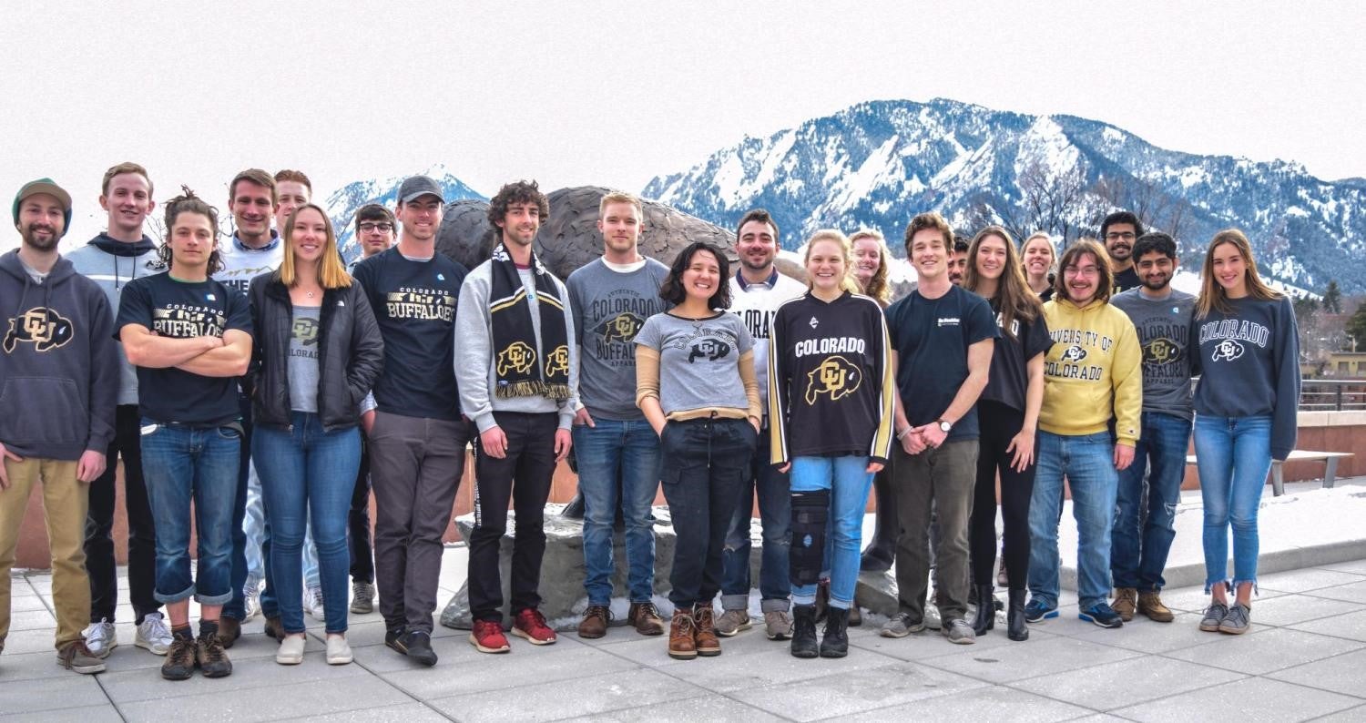 The Solar Decathlon team in their CU gear, with snowy Flatirons in the background.