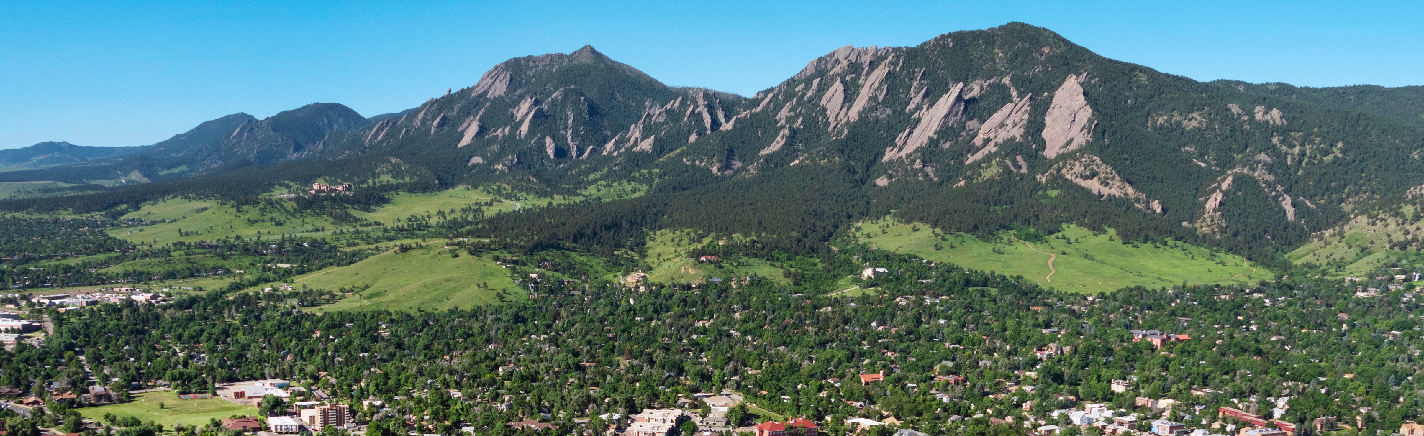 An aerial shot of Boulder and the Flatirons