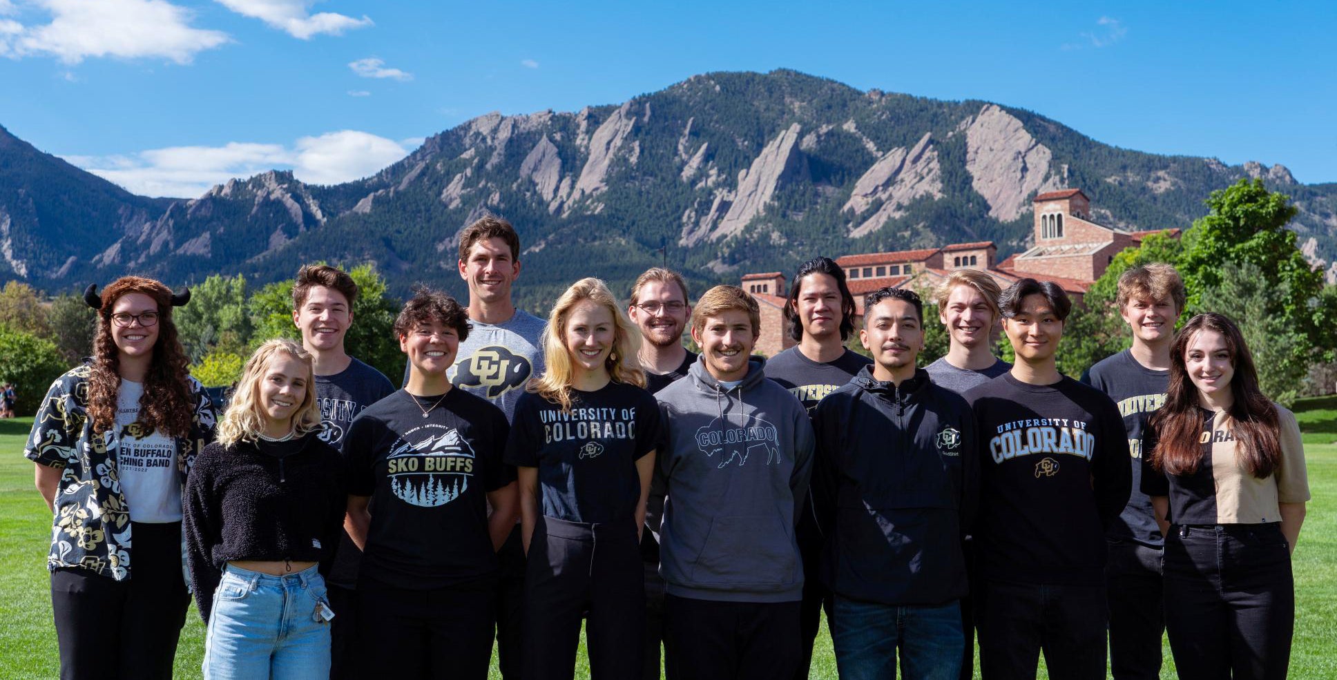 The Wind Team poses for a group photo on the Business Field, with the Flatirons in the background