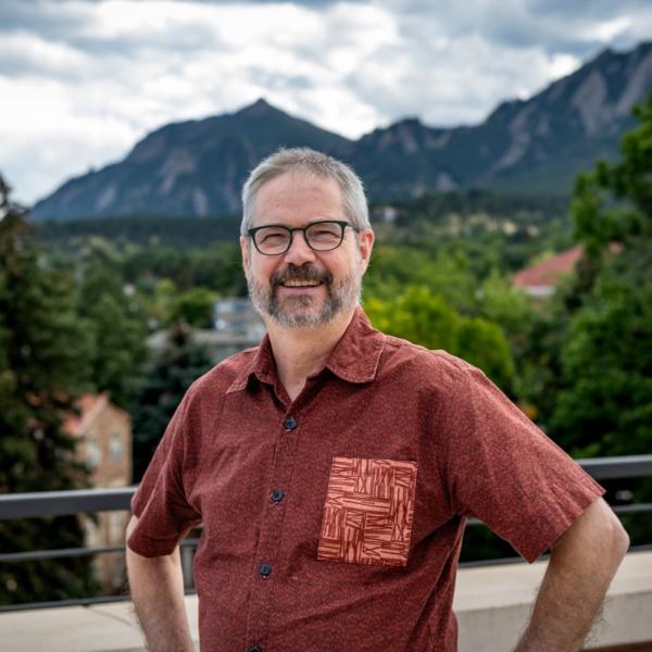 Robin Burke standing outside with flatirons in distance