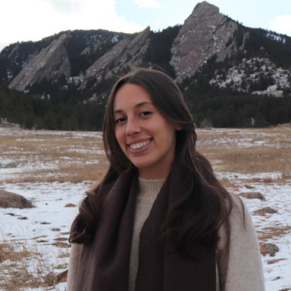 Nicole Frey standing in front of snow and flatirons