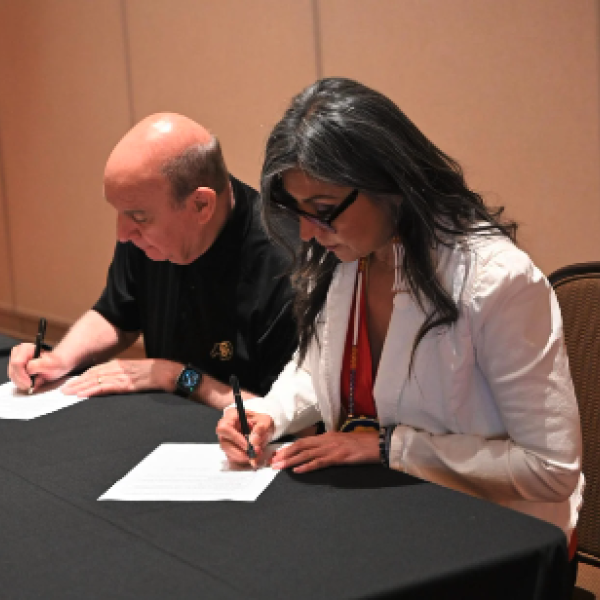 Chancellor Philip DiStefano and Tribe Vice Chairman Lorelei Cloud sign the CU Boulder Tuition and Fee Partnership Program