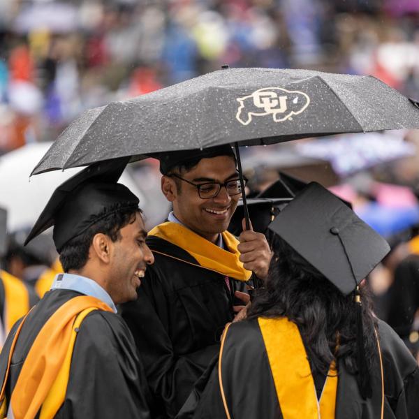 Grads under umbrella