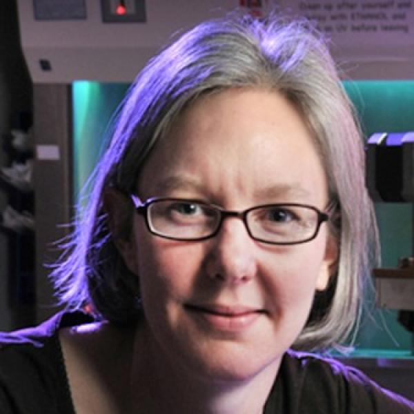 white woman with chin length blond hair wearing glasses