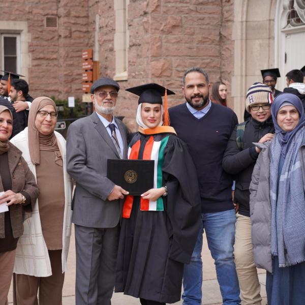 Graduate posing with family