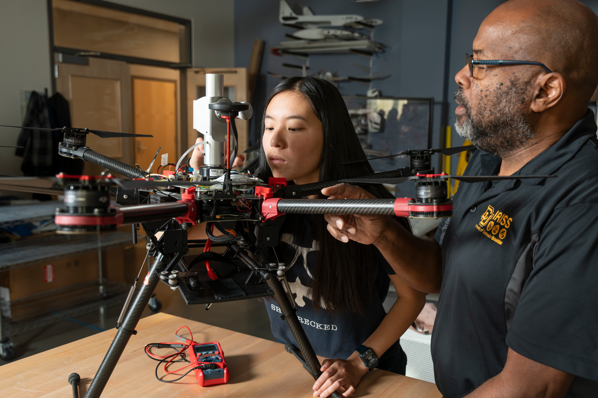 A graduate student and professor in the aerospace fabrication lab at CU Boulder