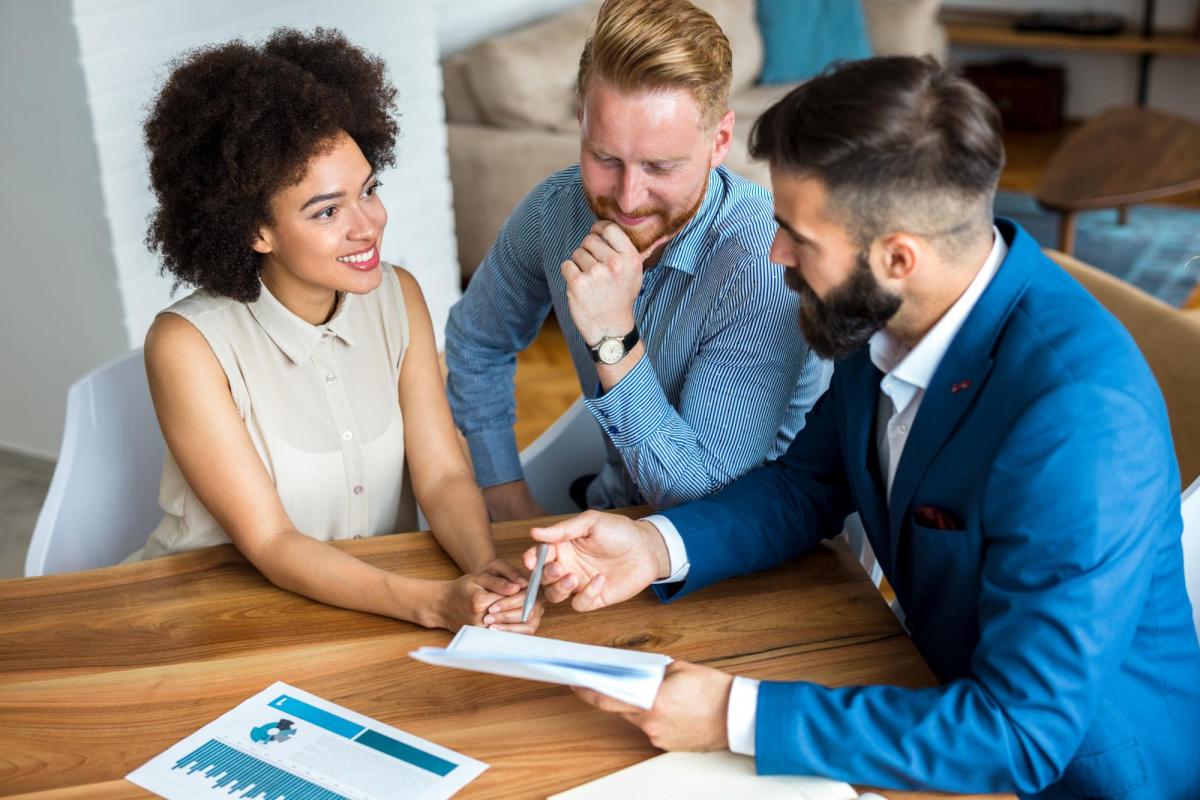 A couple going over documents with a real estate agent.