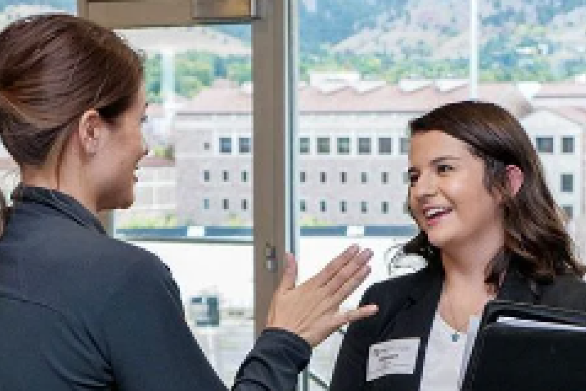 A woman smiles during an interview with an employer