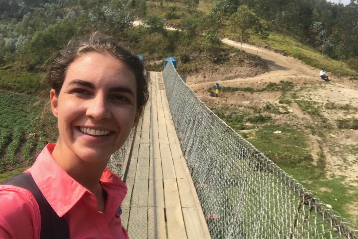 Sally Gerster in front of a footbridge in Rwanda.