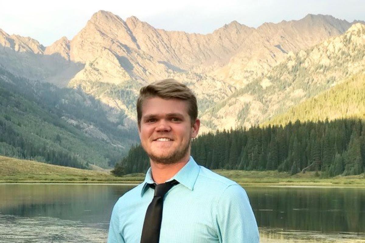Peter Heller in front of a mountain lake