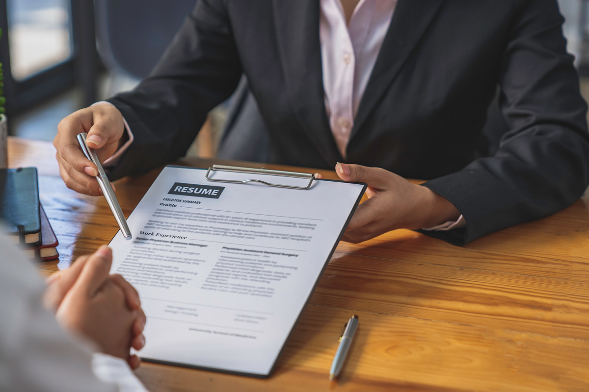Person holding a resume at an interview
