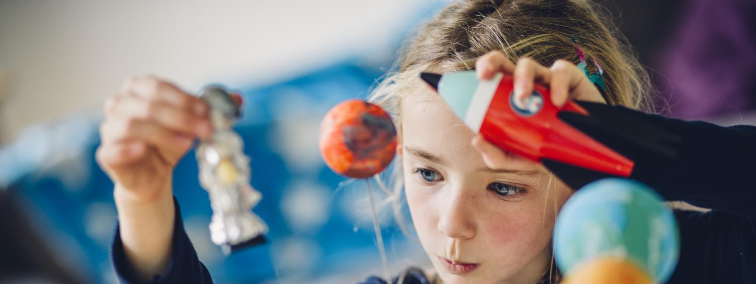 Child playing with science toys 