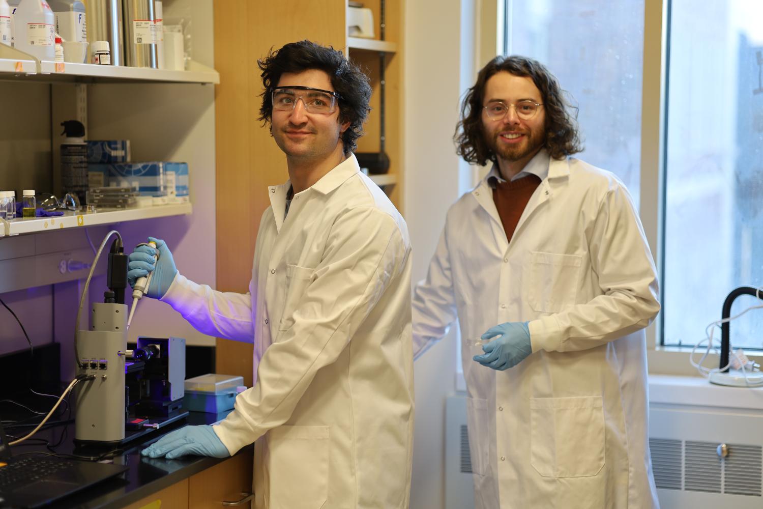 Two men in white lab coats conducting research.