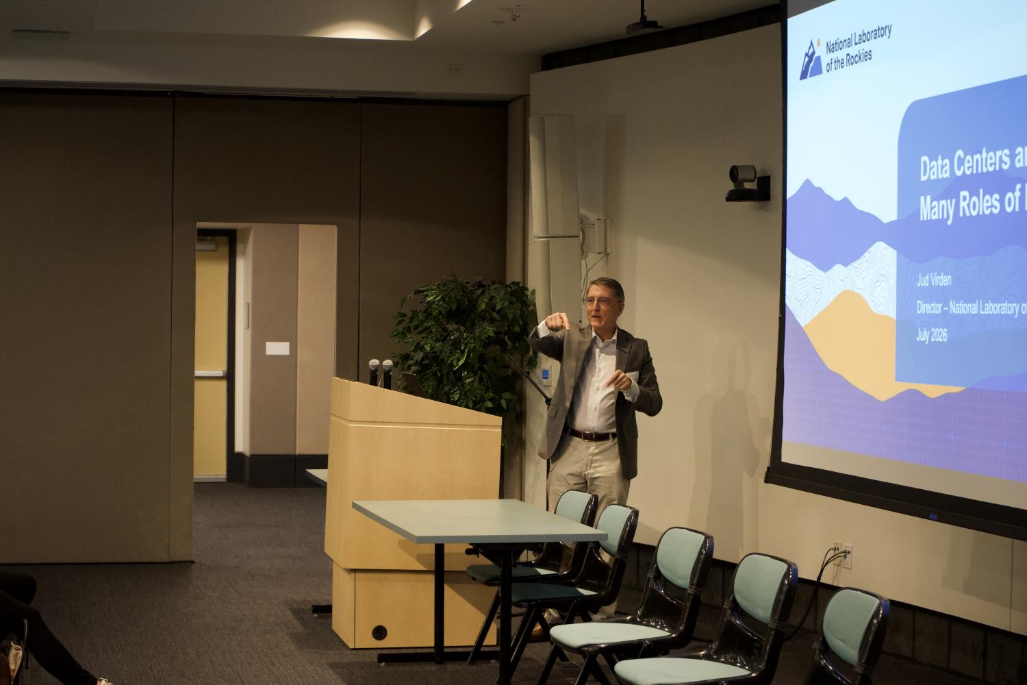 A person at a podium giving a presentation at a conference
