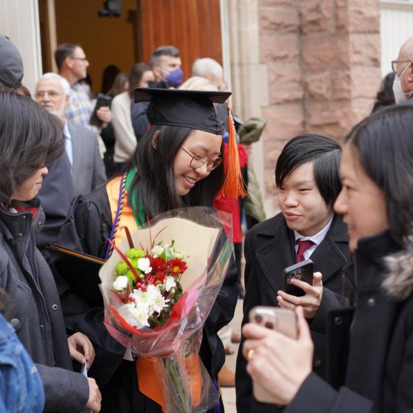 Grad holding flowers