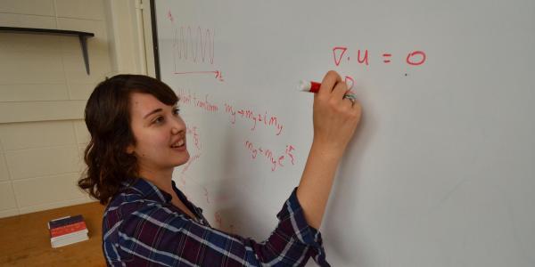 student doing problem on white board