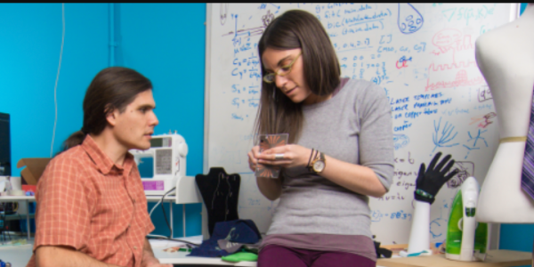 Two researchers speaking in the lab