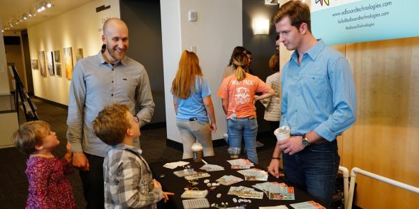 Two children visit the EdBoard booth at Demo Days.