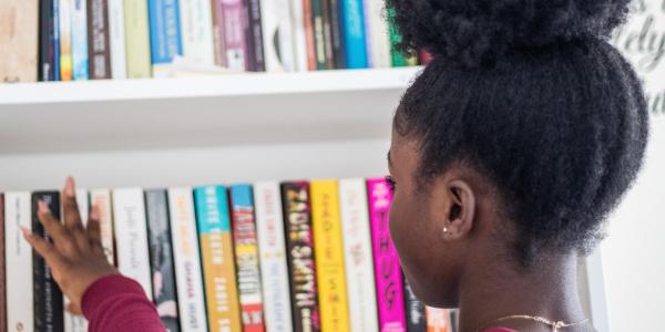 Woman picking a book