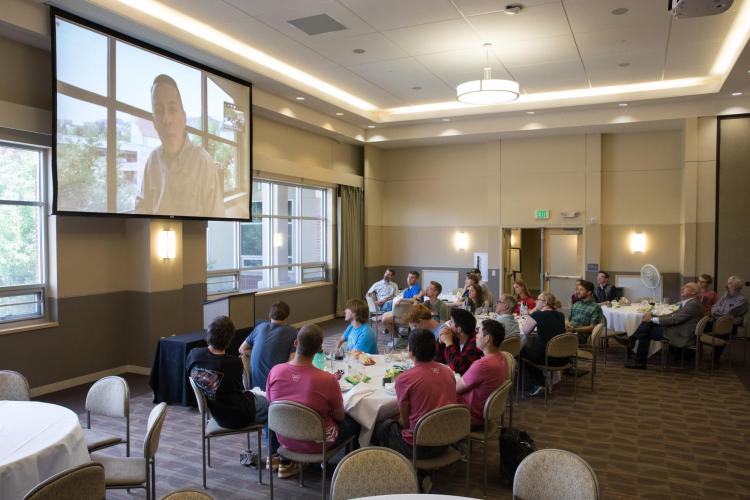 Students listen to Dea n Braun at welcome lunch