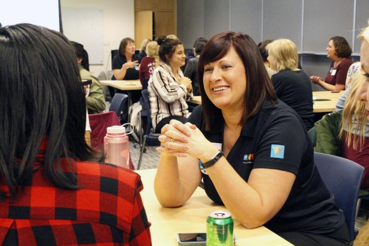 Ball employee talks with female engineering student.