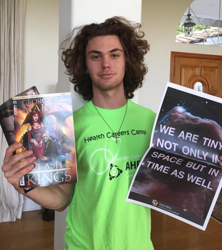 Student Aristotle Bougas holds his comic books and care package items