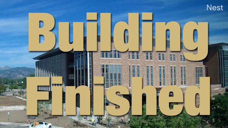 Photo of the building with overlaid text saying "Building Complete"