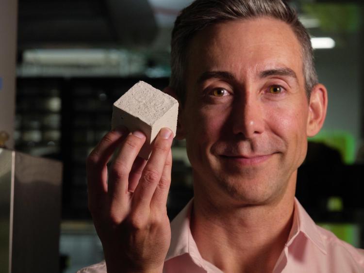 Srubar holds a living concrete sample in his lab