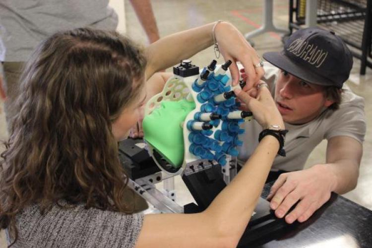 Students working on pediatric brain imaging equipment 