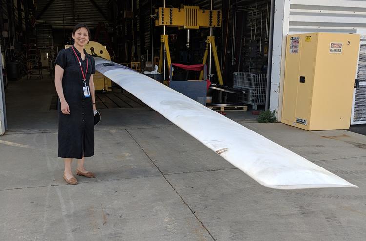 Photo of Pao with the blade after it was delivered to NREL.