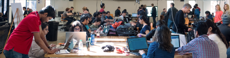 Groups of students on computers at ITP Hackathon