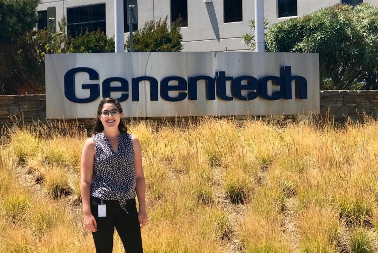 Madeleine Sitton with Genentech sign