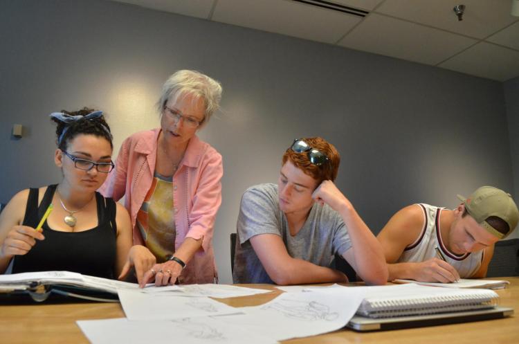 Students work with an instructor on a project. 