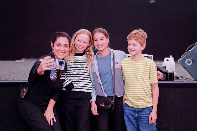 Taking a selfie with K-12 students.