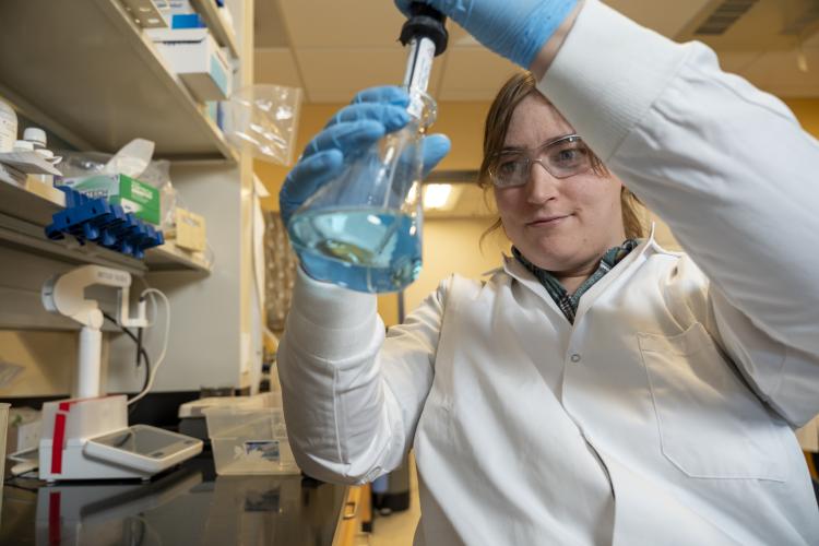Julie Korak testing water samples in a lab.