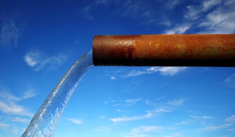Rusty pipe pouring out water