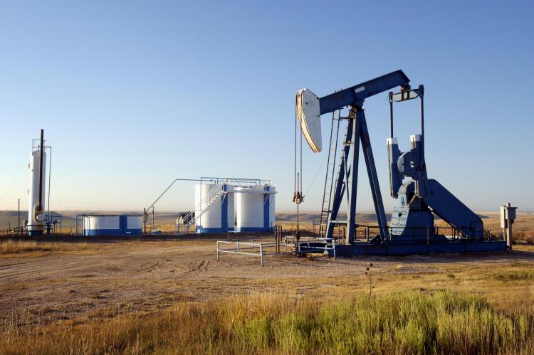 Oil well and storage tanks in a field