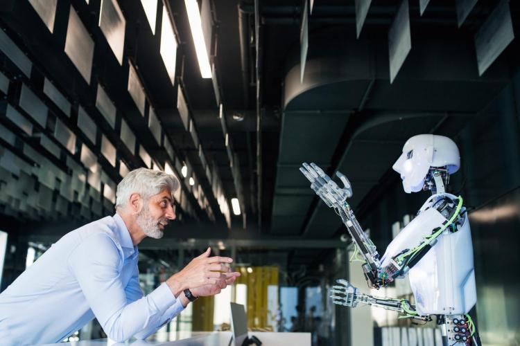 A man and a robot talking to each other