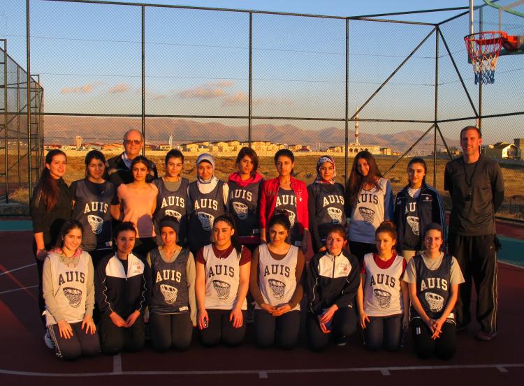 Dave Clough with members of the AIUS women's basketball team