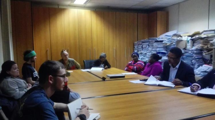 B2P team members around a conference table with representatives from Swaziland Microprojects.