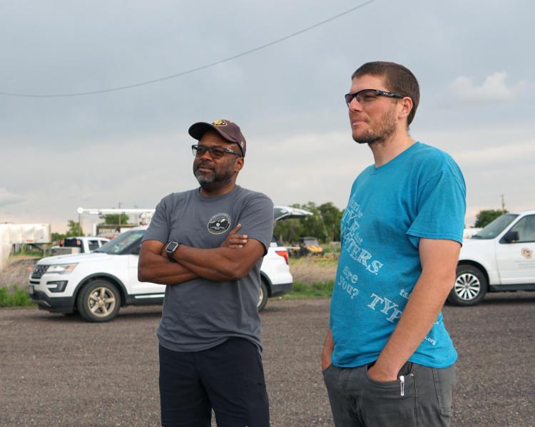 Brian Argrow talking to a colleague in the field