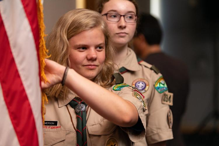 Emerson Domke in scout uniform holding flag